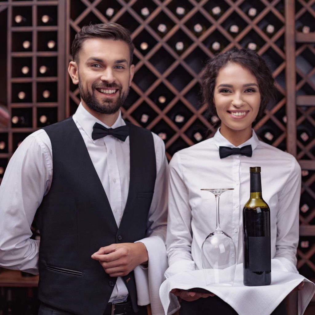 waiter and waitress serving wine