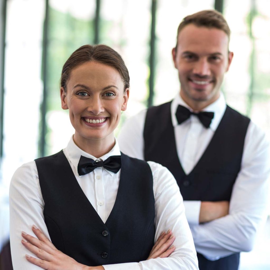 two waiters smiling