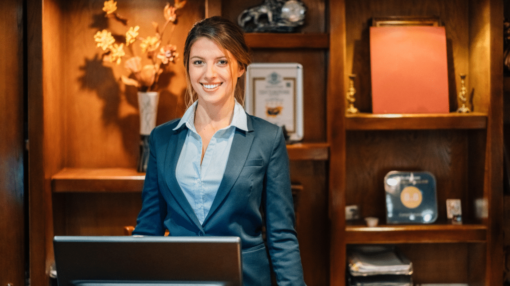 happy front desk agent at hotel smiling